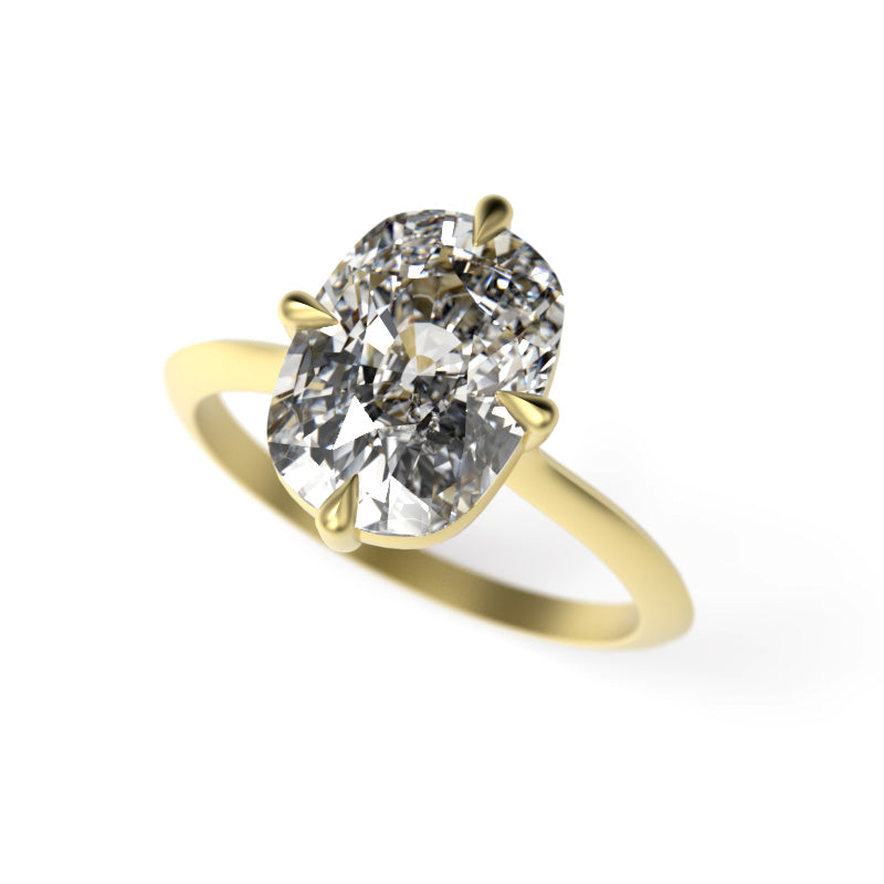 Close-up of an elongated cushion diamond solitaire engagement ring with compass prongs and a yellow gold knife-edge band.