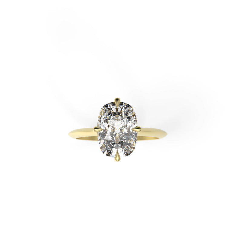 Top view of an elongated cushion diamond solitaire engagement ring with compass prongs and a yellow gold knife-edge band.