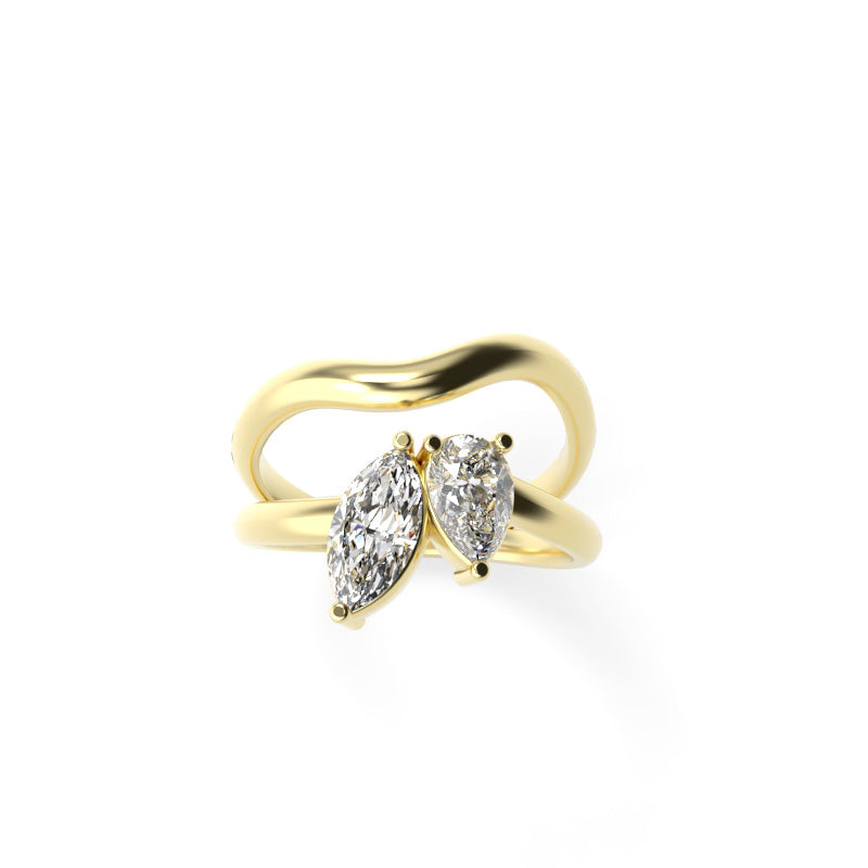 Front view of a yellow gold toi et moi ring with marquise and pear-shaped diamonds in a flowing sculptural band.