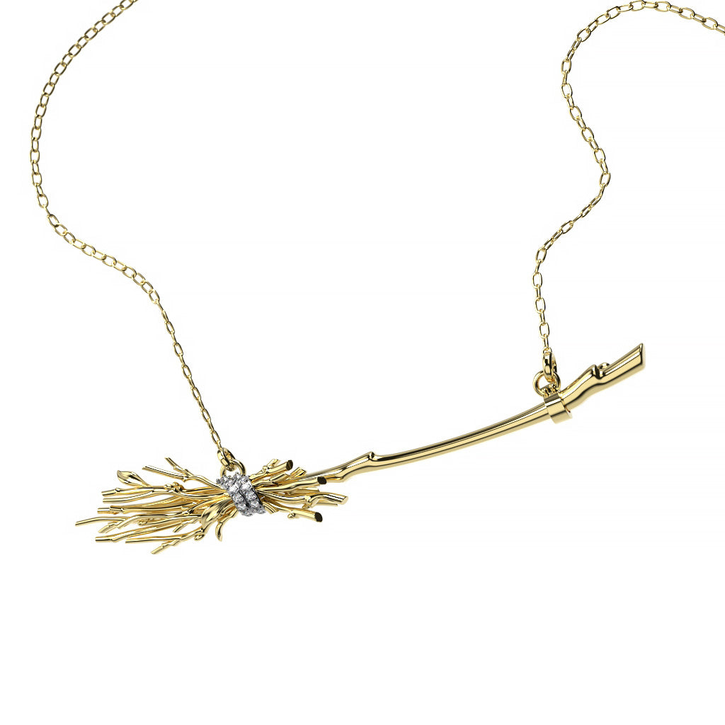 Front view of a yellow gold witch broom diamond pendant necklace with branch-like sculptural details, a curved handle, and diamond-accented wrap.