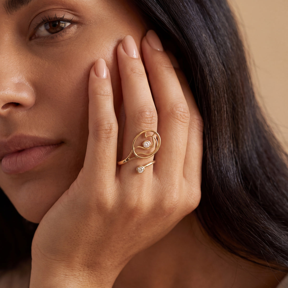 Woman wearing a yellow gold tennis racket ring with diamond accents