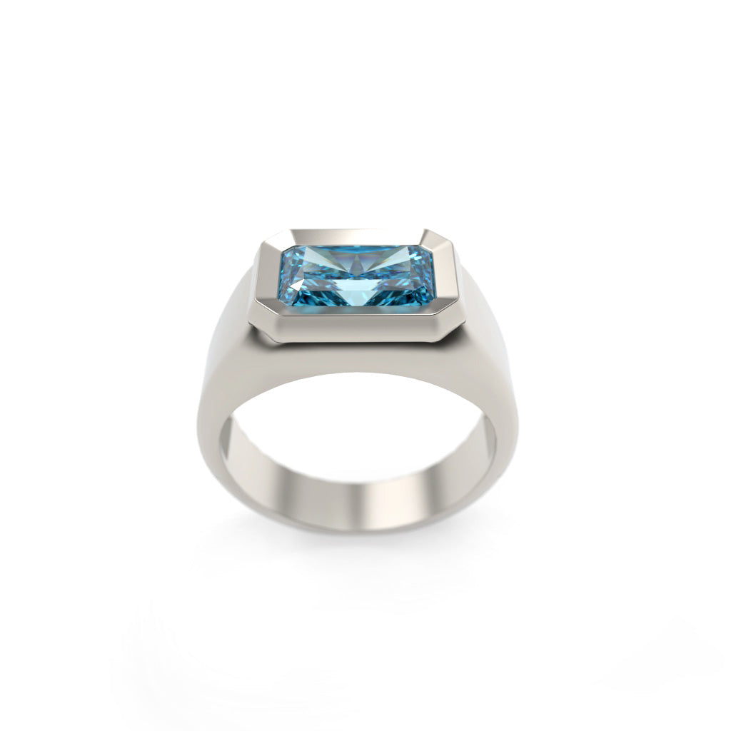 Low front view of a blue diamond signet ring showing the raised bezel and tapered band