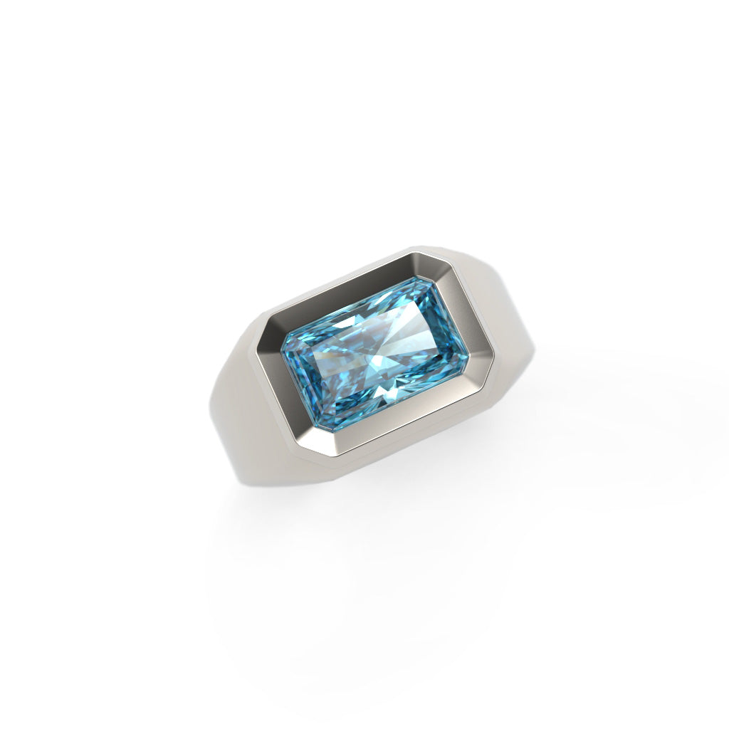 Angled top view of a men’s blue diamond signet ring with a beveled bezel setting
