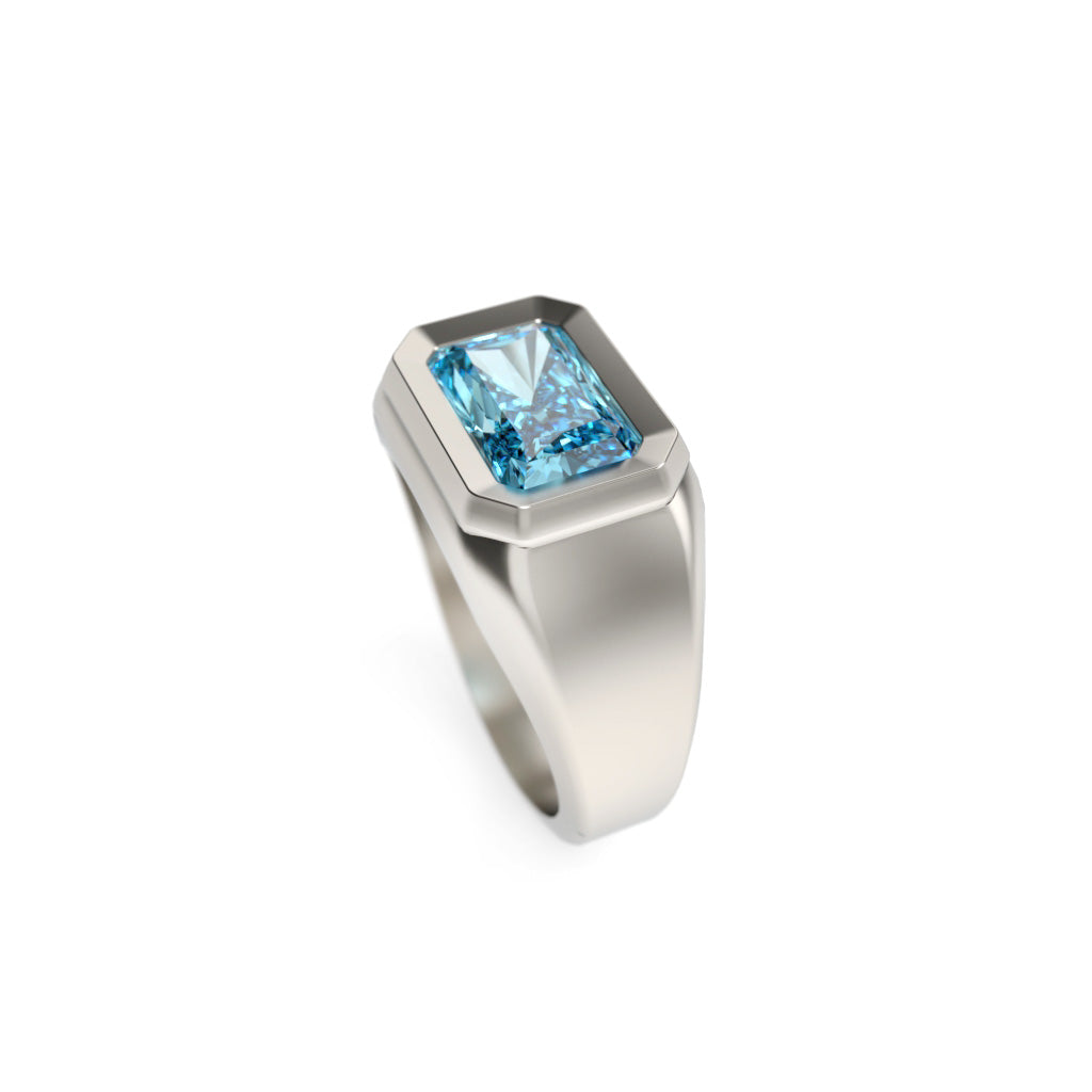 Side angled view of a blue diamond signet ring showing the broad polished shoulder