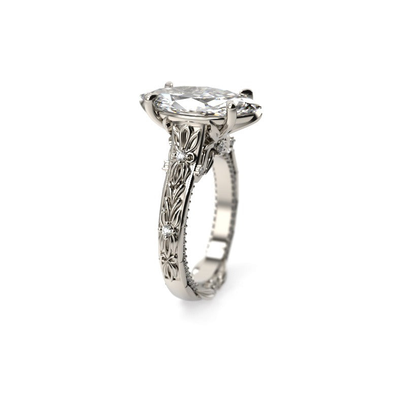 Angled profile of a marquise diamond engagement ring showing the raised prong setting and pavé diamond edging.