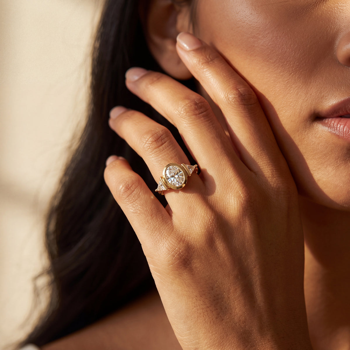  delicate engagement rose gold ring with a oval cut diamond and small side stones.