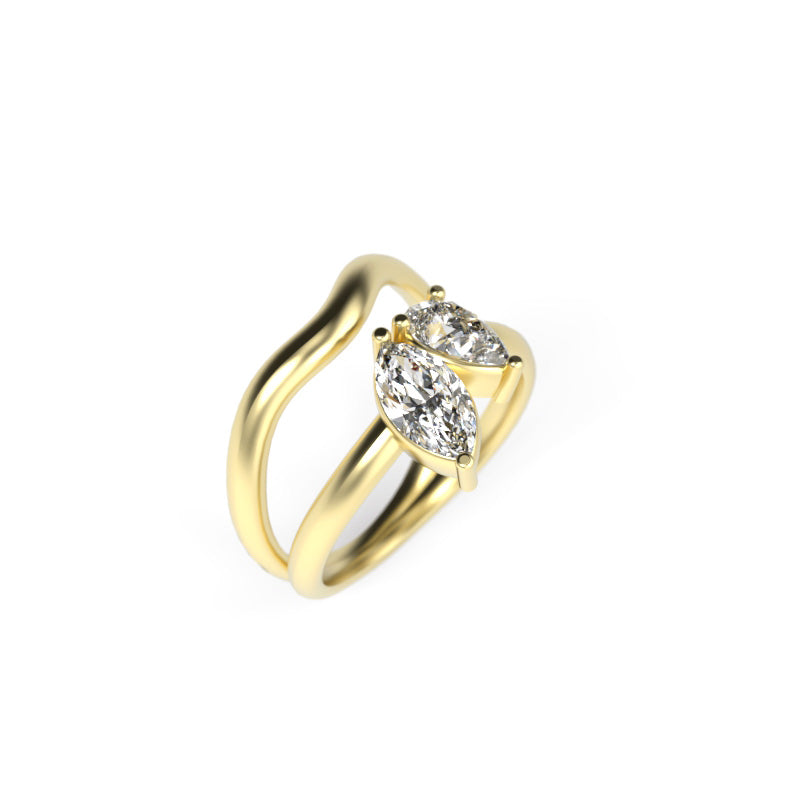 Side view of a yellow gold toi et moi ring with marquise and pear-shaped diamonds in a flowing sculptural band.