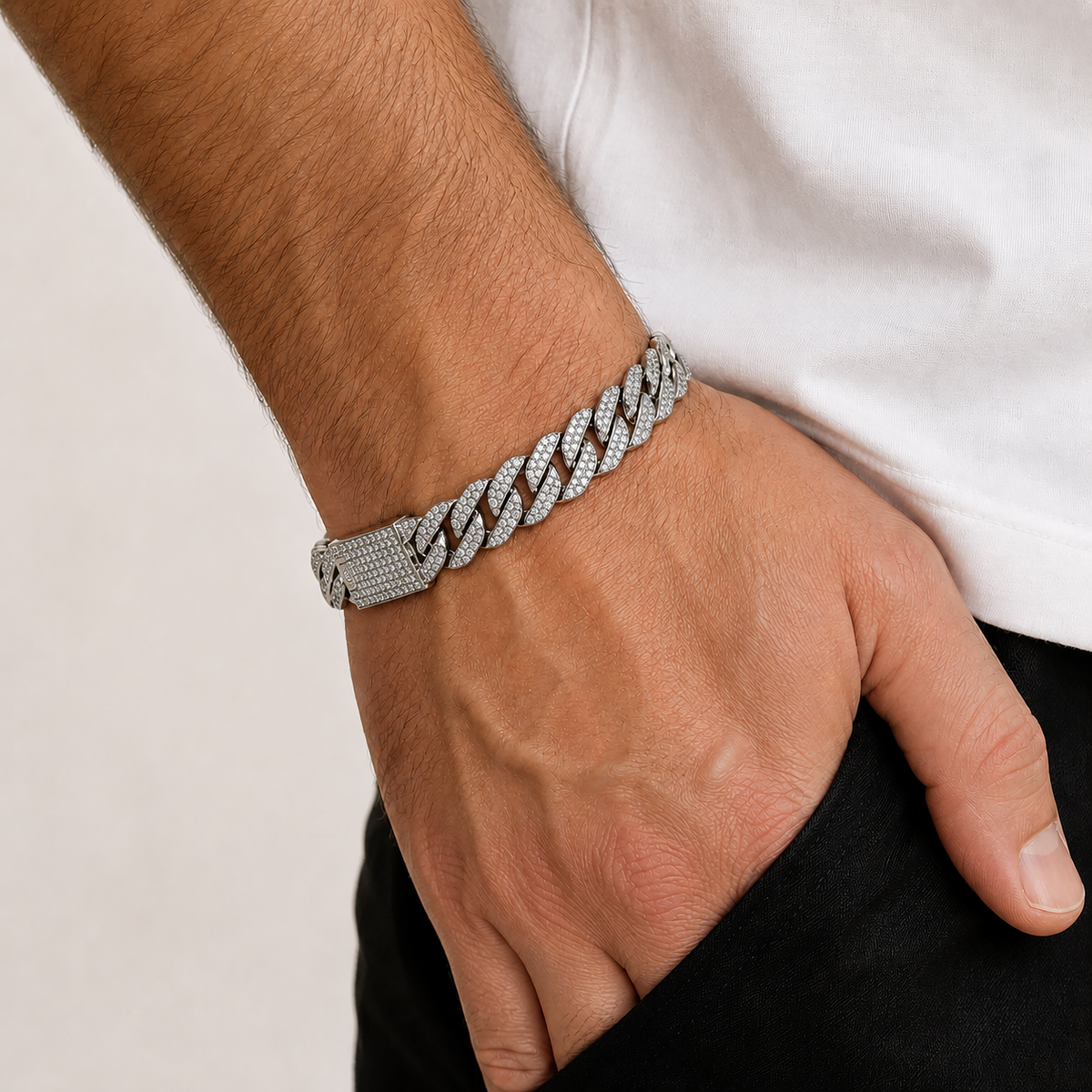 Men’s white gold Cuban link bracelet fully set with pavé diamonds, shown on a wrist.