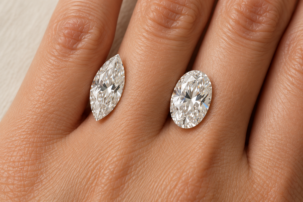 Close-up illustration of loose marquise and oval diamonds resting on a hand.