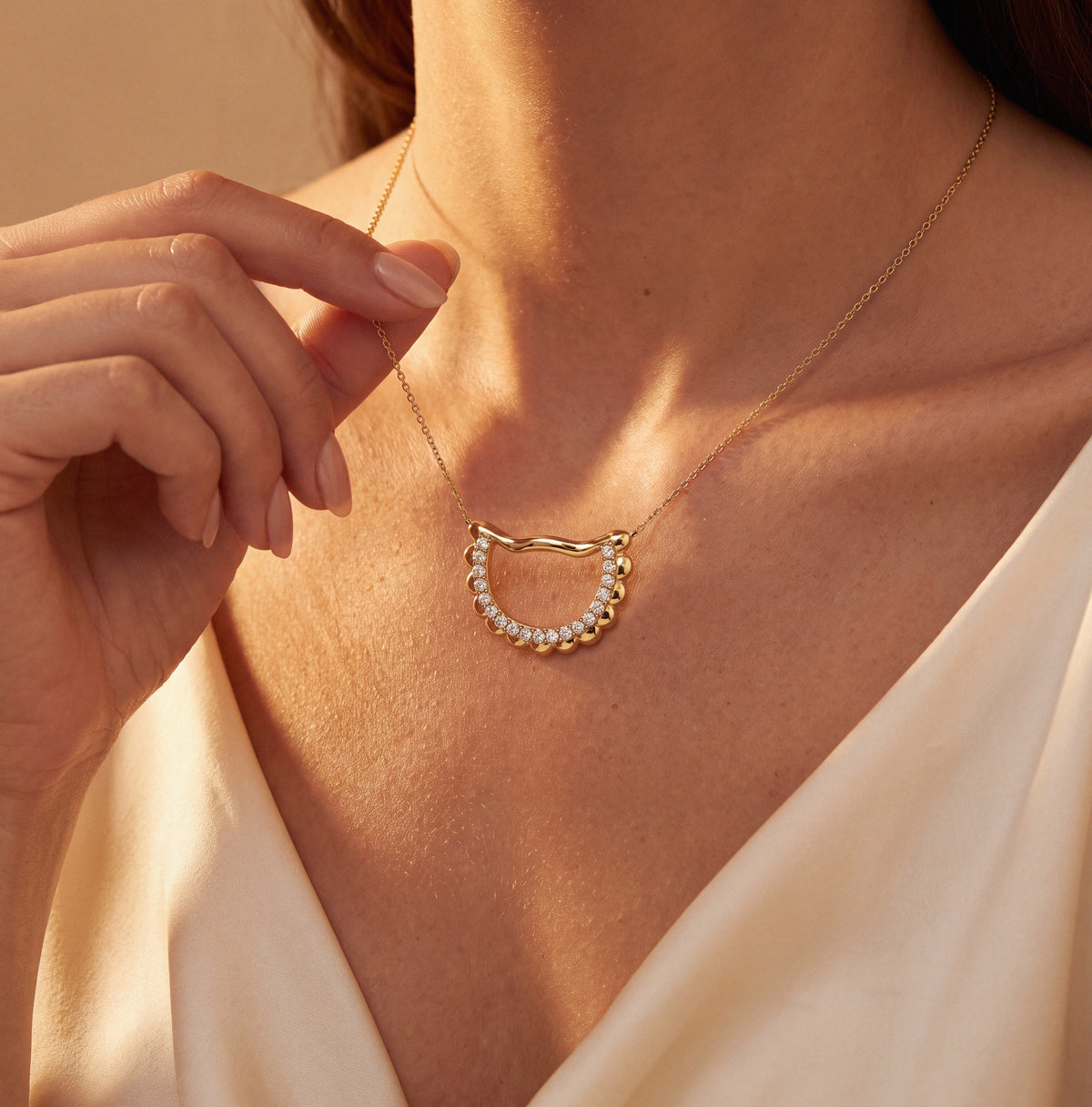 Woman wearing the Pierogies Pendant, a custom yellow gold necklace set with pavé diamonds.