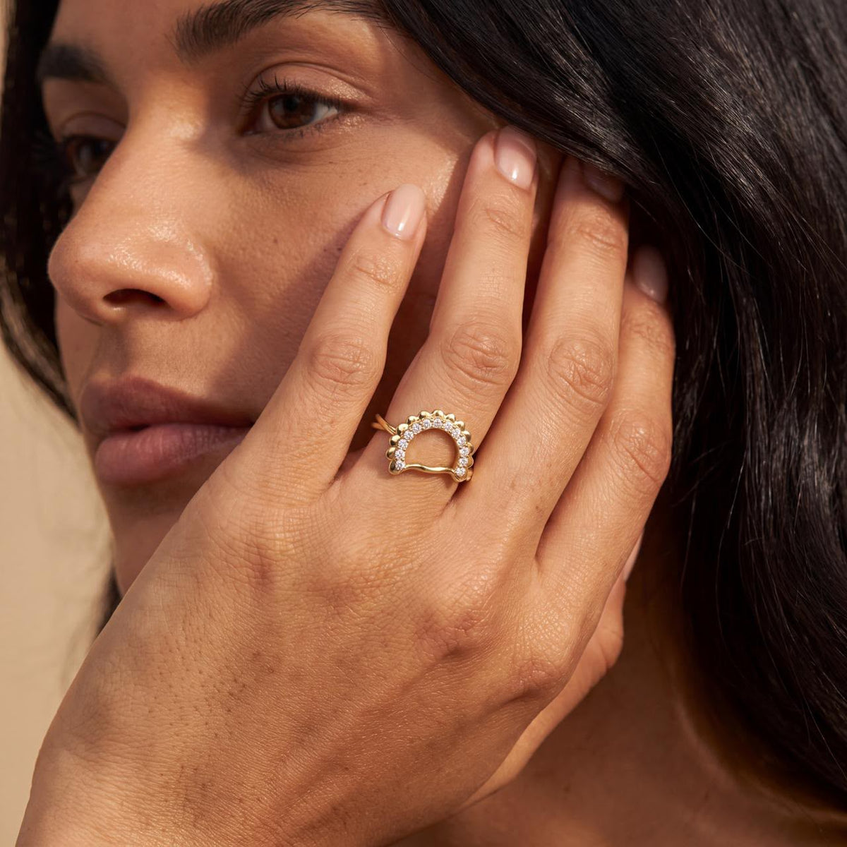 Woman wearing the Pierogies Ring, a custom yellow gold design set with pavé diamonds